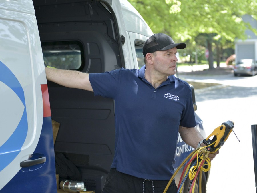 A licensed Sam's Air Control technician working from a service van